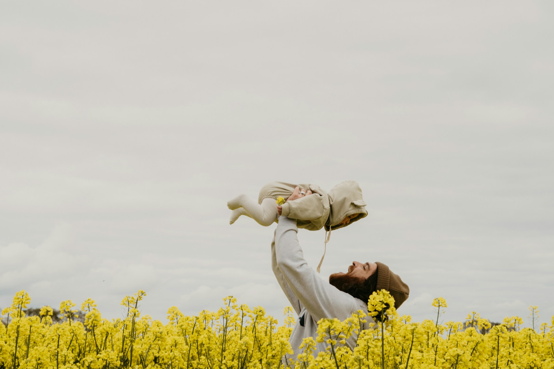 a man holding his child in a park