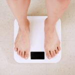 a person on scale to check weight