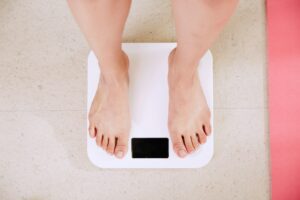 a person on scale to check weight