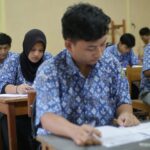 group of students are taking exam in the class room