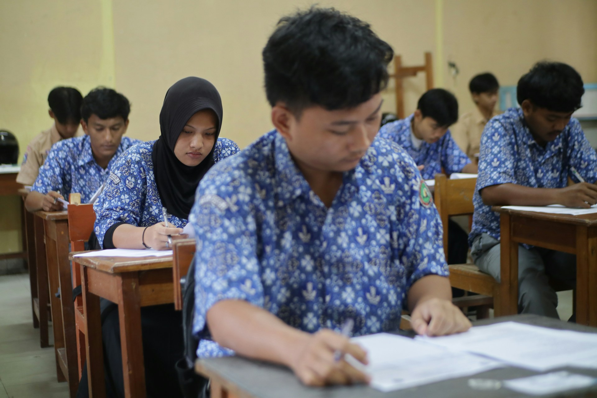 group of students are taking exam in the class room