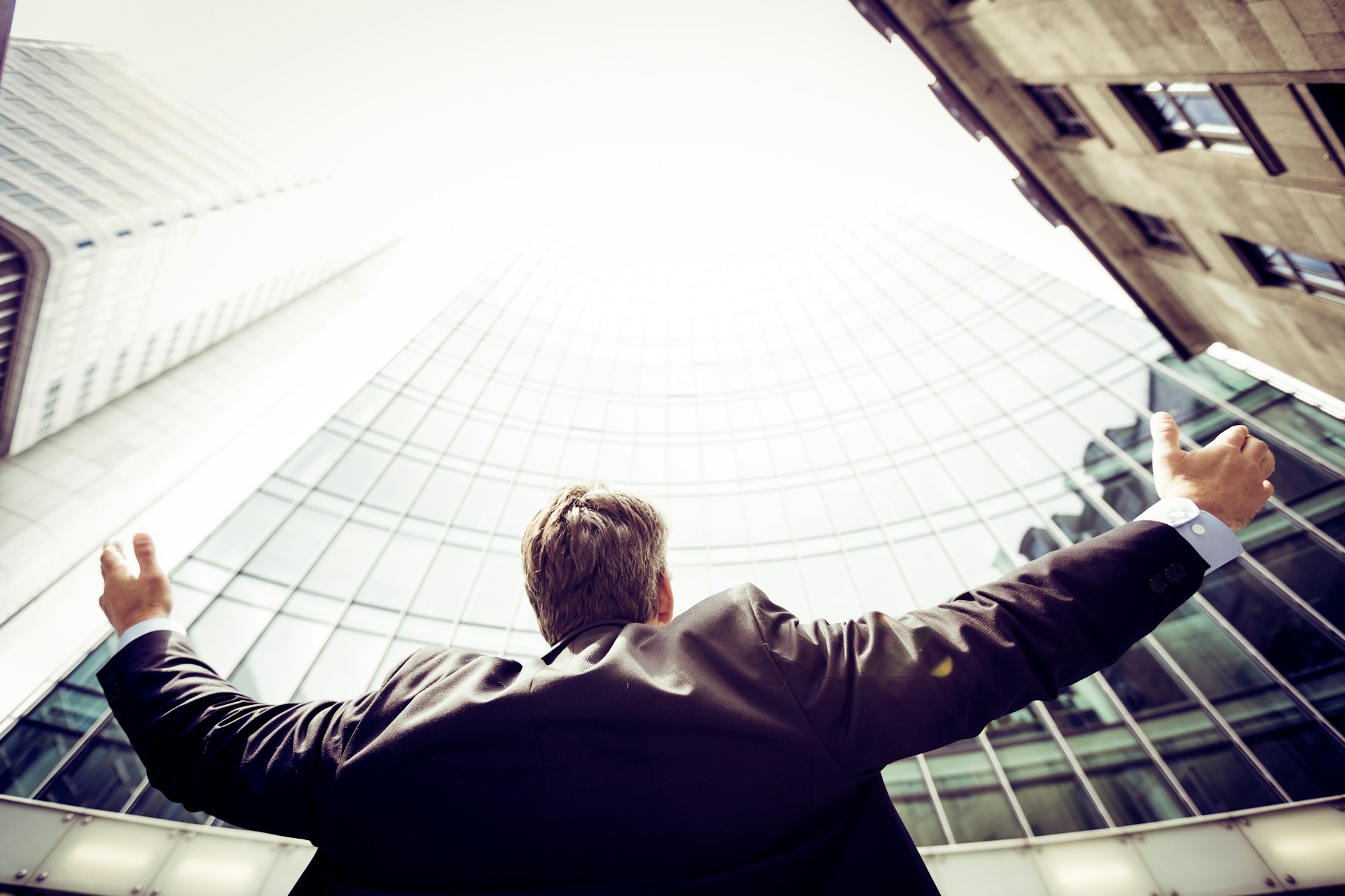 a man with suit in front of a building