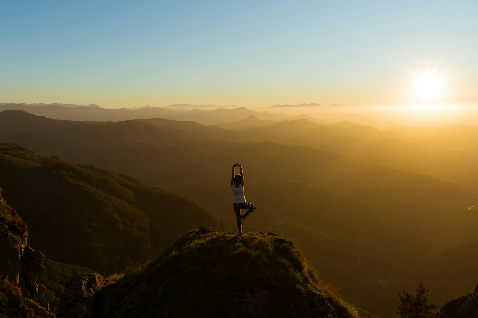 a woman doing yoga in sunset