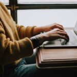 a person is working remotely with a laptop
