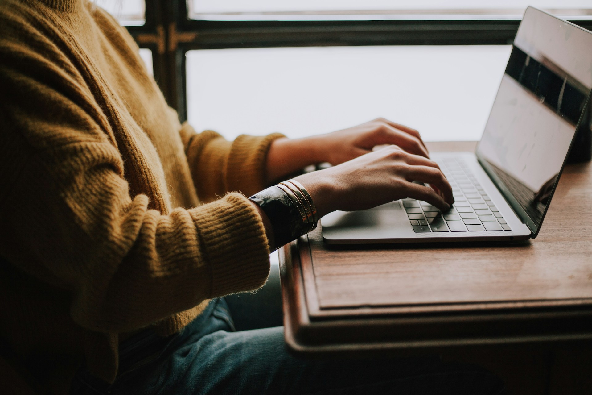 a person is working remotely with a laptop